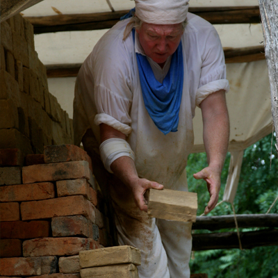 a man stacking bricks in preparation for a brick restoration project