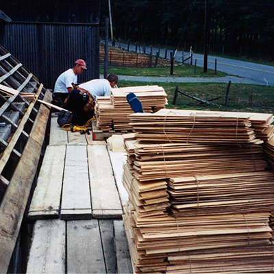 two men preparing custom made side lap shingles