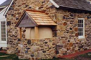 Looking at the outside of a restored squirrel tail oven