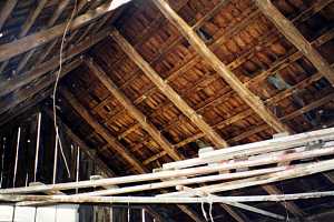 interior image of crumbling roof with holes