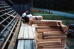 workers preparing wood for new shed roof