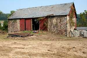 an old stone barn in need of repair