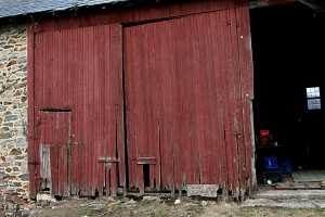 damaged wooden door to an old barn