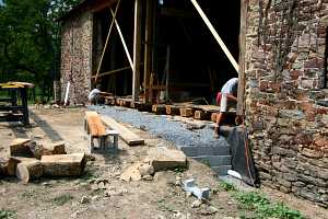 installation of new wood logs in an old barn