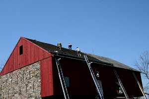 workers installing the new roofing