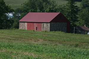 an after picture of the barn with the new door and roofing