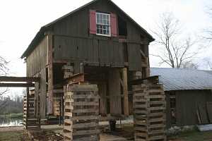 barn raised on steel beams for foundation renovation