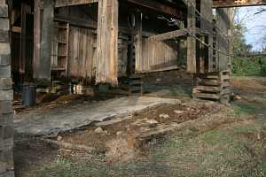 barn suspended on steel beams for foundation restoration