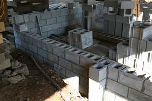 cinderblocks being stacked for a new barn foundation