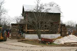 barn suspended above new concrete foundation