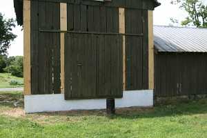 barn exterior being reassembled after being secured to new foundation