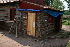 log cabin exterior being repaired