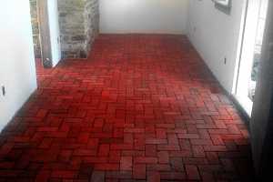 a red brick floor inside a building
