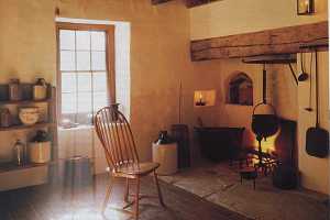 a brick floor inside a historic home looking at the kitchen area