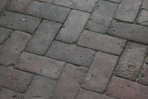 a closeup photo of an old brick walkway