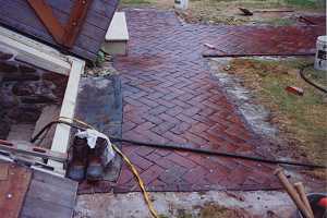 a brick walkway leading to a cellar