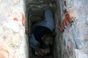 A man repairing an old chimney flue