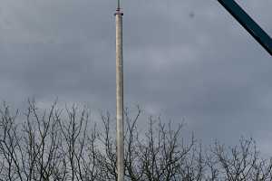 A chimney duct being installed via crane