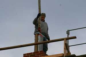 A chimney duct being installed via crane