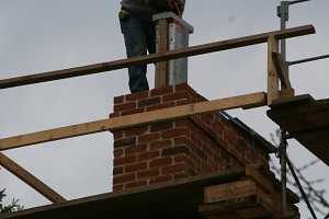 A chimney duct being installed via crane