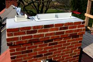 The top of a fully restored chimney with dampers installed