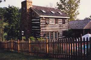 A log cabin with stone chimney