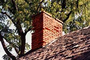 A brick chimney with some damage