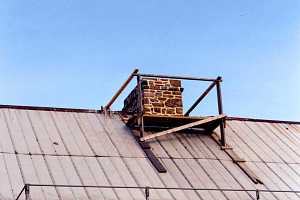 A stone chimney and platform for working on it