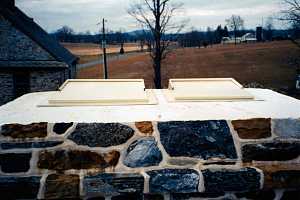 Top of stone chimney looking at the two flue dampers