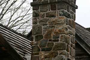 A decorative stone chimney with arch