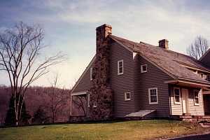 A stone chimney running up the side of a home