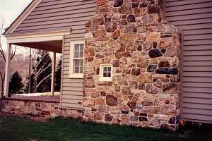 A stone chimney and a window in the chimney