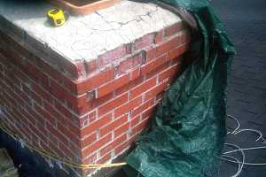 Closeup of brick chimney damage