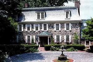 Restored cobblestone driveway and accompanying house