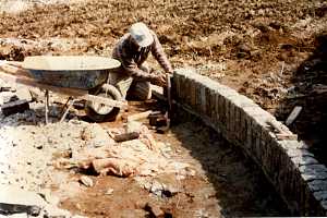 Man assembling a cobblestone driveway