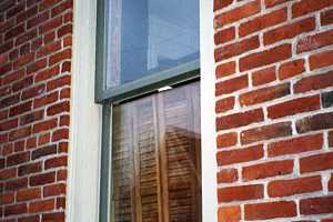 a window on a brick home