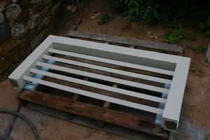 a wooden window grate sitting on a wooden skid