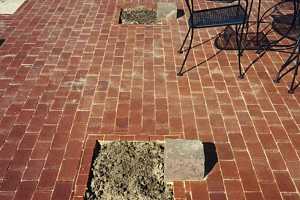 Cut out sections of a brick porch waiting for custom cut stones