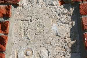A faded date stone needing repairs