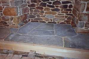 a newly restored custom stone fireplace hearth