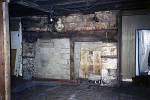 rotting wood and crumbling stone fireplace - before