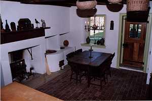 a fully restored historic kitchen area with fireplace