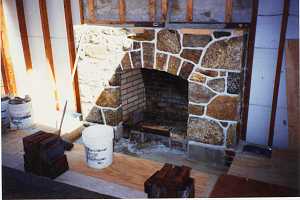 a natural stone fireplace missing a base and mantel