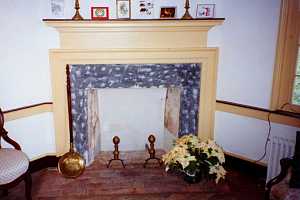 a restored fireplace with a flower on the brick base - after