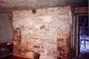 a historic building interior where a fireplace was previously filled in - before