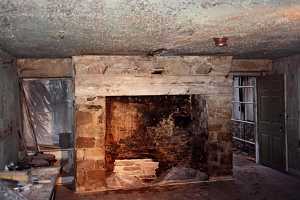 stone fireplace with new wood beam at the top