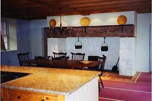 decorated kitchen and fireplace area of a historic home