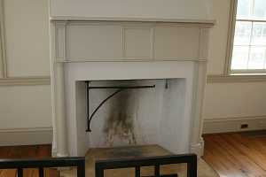 a fireplace with tan mantel