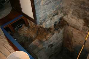 digging out the stone in a fireplace chimney