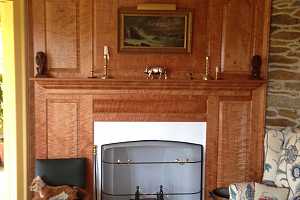 fully restored fireplace area with wooden mantle - after